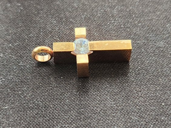 A modern cross pendant in gold-tone stainless steel