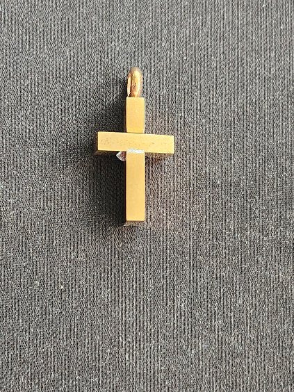 A modern cross pendant in gold-tone stainless steel
